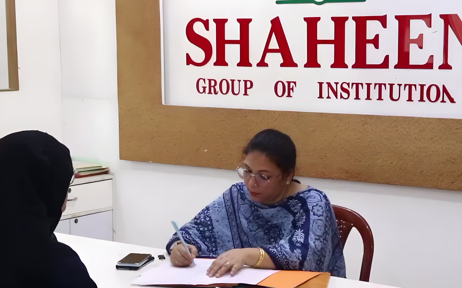 The Shaheen office beneath the Group of Institutions signboard